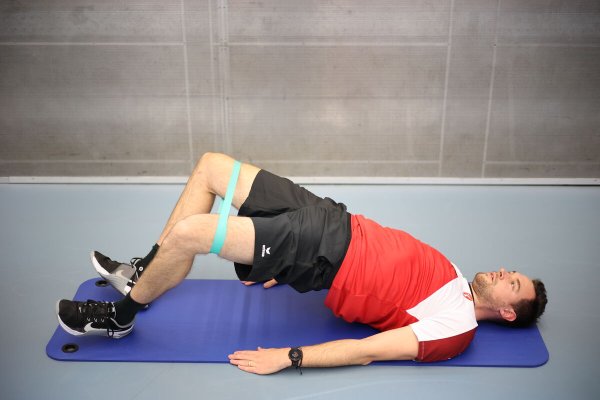Abduction and adduction of the legs in shoulder position glute bridge ...